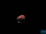 an image of a red object in the dark with a black background