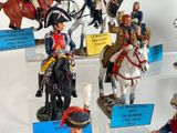 many figurines of soldiers on display in a display case