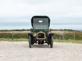 a old green truck parked on the side of the road