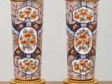 pair of vases with floral designs on them on a table