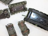 a lot of toy army vehicles that are on the table