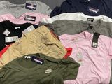 a lot of men ' s polo shirts sitting on a table