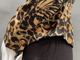 an image of a mannequin wearing a leopard print shirt and black pants