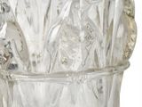 a glass vase with a design on it on a table