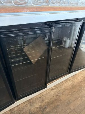 two glass doors that are open on the side of a building