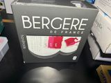 a box of wine sitting on a table with a wine glass in it