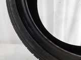 a close up of a tire on a white surface with a white background