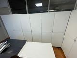 a white refrigerator and a black counter in a kitchen
