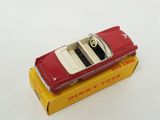 a red toy car sitting on top of a yellow box