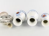 three vases are sitting next to each other on a white surface
