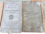 several old books sitting on top of each other on a table