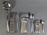 a lot of silver spoons and spoons on the table