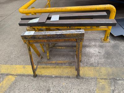a bench that is sitting in the middle of a parking lot