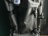 a backpack that has a tag on it on a table