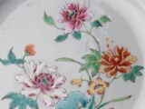 a plate with flowers on it sitting on a table
