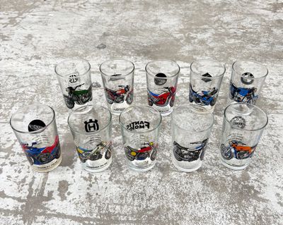 a lot of glasses that are lined up on the ground