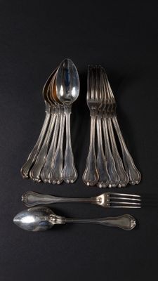 a lot of silver spoons and forks on a black surface