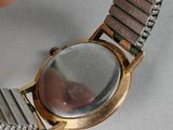 a person that is holding a watch in their hand