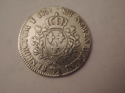 a close up of a silver coin with a crown on it