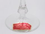 a wine glass with a red label on it