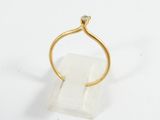 a gold ring with a diamond on top of a clear quartz block