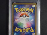 a close up of a pokemon card on a black surface