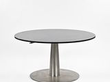 a close up of a table with a metal base and a glass top