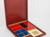 une boîte en bois contenant quatre carreaux colorés