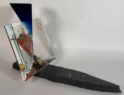 a picture of a mirror and a rock on a white surface