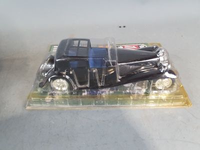 a model of a black car in a clear box