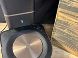 a speaker that is sitting next to a speaker on a table