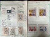 an open book with stamps and stamps on it sitting on a table