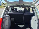 the back of a car with its trunk open on the side of the road