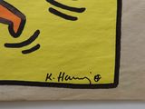 un morceau de papier jaune sur lequel est dessiné une main tenant un couteau