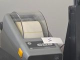 two computers and a printer sitting on a desk