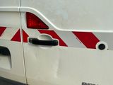une camionnette blanche avec une bande rouge sur le côté