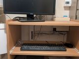 a computer desk with a monitor and keyboard on it