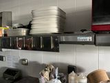 a kitchen with a lot of dishes on the shelves
