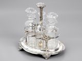 an antique silver plate with a tray of salt and pepper shakers on it