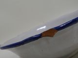 a white bowl with a blue rim sitting on a table