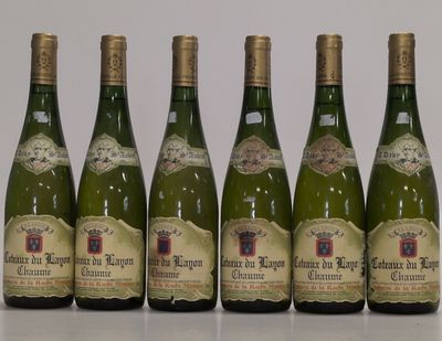 six bottles of wine are lined up in a row on a table