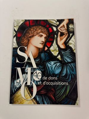 a close up of a book with a stained glass window in the background