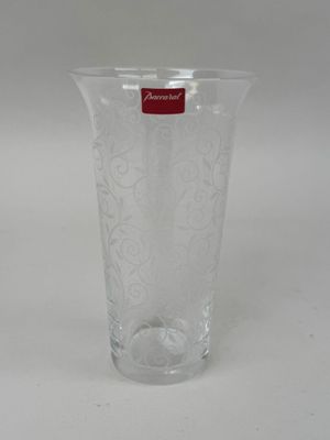 a clear glass vase with a red label on it