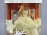 doll in a box with a snowflake on top of it