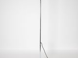 a black and white photo of a floor lamp on a white surface