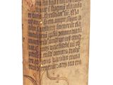 un vieux livre sur lequel on voit des inscriptions sur une surface blanche