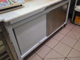 a counter with a laptop on it in a kitchen