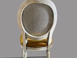 an image of a white chair with a yellow cushion on it