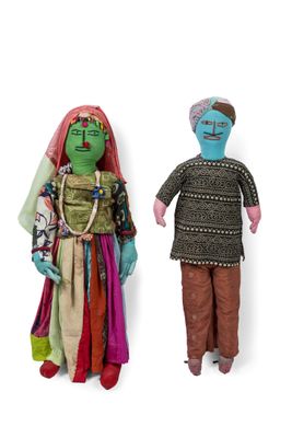 two dolls that are standing next to each other