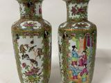 pair of chinese vases with oriental scenes on them on a white background